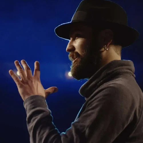 Medium close-up of an actor performing a monologue in a theater while holding his script